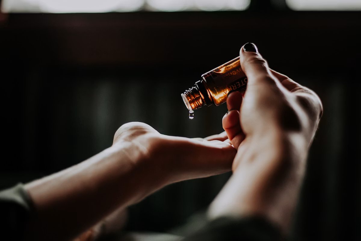 Amber oil being dispensed into an open palm